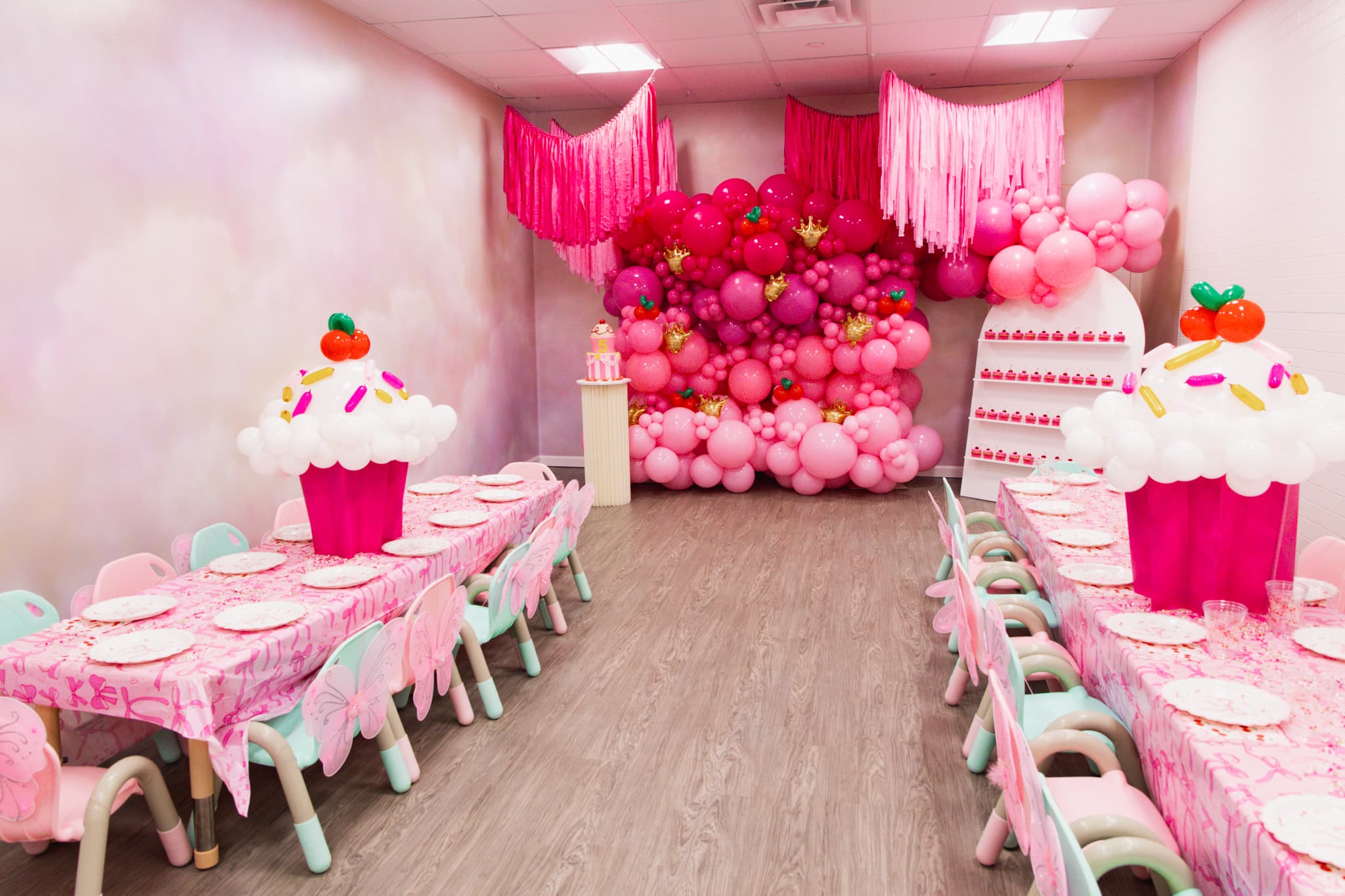 Pink balloon backdrop party room